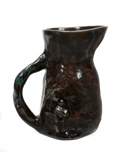 STAN & GEOFF GILBERT hand-built pottery jug decorated with a swagman in landscape, 16.5cm high