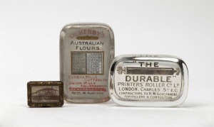 "W. LEEMING BOOT STORE No.1 ERROL STREET NORTH MELBOURNE" antique advertising vesta with photographic top, together an antique glass paperweight advertising "OCKERBY'S HIGH CLASS AUSTRALIAN FLOURS.....PERTH W. AUSTRALIA" with calendar function, plus "THE DURABLE PRINTER'S ROLLER" glass paperweight, 19th century, (3 items), the largest 11cm high