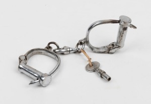 Antique nickel plated adjustable handcuffs with screw key, 24cm wide