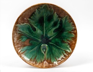 McHUGH green and brown glazed pottery leaf plate, incised "H. McHugh, Tasmania", 24cm diameter