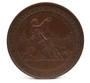 MEDAL: 1879 SYDNEY INTERNATIONAL EXHIBITION large bronze medal by Wyon (76mm), engraved to "W. BENNETTS, FIRST PRIZE". This is a large bronze prize medal featuring a view of the Sydney Garden Palace Exhibition Building with a figure of New South Wales standing in front holding the colonial shield and surrounded by exhibition goods.