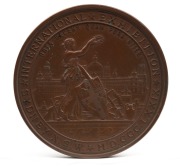 MEDAL: 1879 SYDNEY INTERNATIONAL EXHIBITION large bronze medal by Wyon (76mm), engraved to "W. BENNETTS, FIRST PRIZE". ​​​​​​​This is a large bronze prize medal featuring a view of the Sydney Garden Palace Exhibition Building with a figure of New South Wa