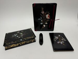 An antique papier-m&acirc;ch&eacute; sewing box with mother of pearl decoration; together with two antique blotters and an antique spectacle case with lorgnette&nbsp;spectacles, 19th and 20th century, (4 items), the sewing box 26.5cm wide