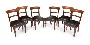 A set of six Colonial Australian cedar spade back dining chairs with faceted tapering legs and drop in black leather upholstered seats, circa 1845