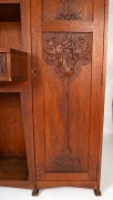 An Australian Arts & Crafts bookcase with knee hole desk compartment, manufactured in American oak, carved with Illawarra flame tree motif, early 20th century, with original ink stamp to the reverse of drawer "MISS GETHERS, WOOD CARVING STUDIO, SYDNEY", 1 - 4