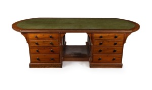 An impressive antique Australian library partners desk with D-ended inset writing surface and crossbanded edge. The pedestals with four graduated drawers to each side standing on a recessed plinth with footrest, circa 1880. Full cedar construction. 66cm high, 272cm wide, 137cm deep