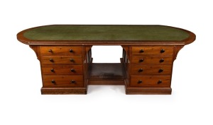 An impressive antique Australian library partners desk with D-ended inset writing surface and crossbanded edge. The pedestals with four graduated drawers to each side standing on a recessed plinth with footrest, circa 1880. Full cedar construction. 66cm h