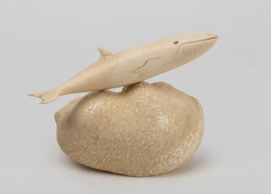 A carved whalebone ornament mounted on a whale ear drum bone, 12cm high, 15cm wide overall