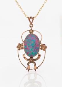 An Australian 9ct gold mounted opal pendant suspended on a 9ct gold chain, early to mid 20th century, stamped "9ct", the pendant 4cm high overall, the chain 40cm long, 5.2 grams overall