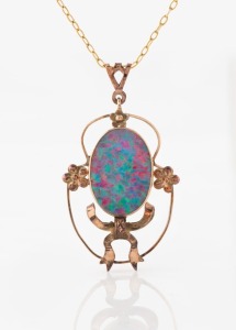 An Australian 9ct gold mounted opal pendant suspended on a 9ct gold chain, early to mid 20th century, stamped "9ct", ​​​​​​​the pendant 4cm high overall, the chain 40cm long, 5.2 grams overall