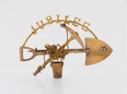 A 9ct gold miner's brooch with crossed pick and shovel emblazoned&nbsp;"JUBILEE", stamped "9ct", 4.5cm wide, 4.75 grams total