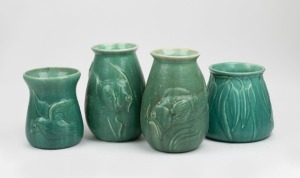 MELROSE WARE group of four green glazed pottery vases, comprising two with fish decoration, one with kingfisher decoration and one with gum leaf decoration, the largest 21cm high