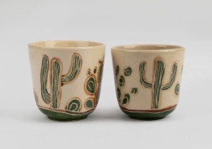 CARL COOPER two pottery teacups with incised cactus in landscape, incised "Cooper" and "Carl Cooper", the larger 6cm high