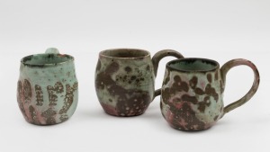 JOHN PERCEVAL three assorted pottery mugs glazed in burgundy and green, all incised "J. P." or  "P.", the largest 9cm high