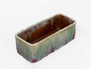 REMUED rare pottery trough, glazed in pink, green, brown and cream, incised "Remued", first example seen in our rooms, 7.5cm high, 23cm wide