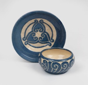 MARGUERITE MAHOOD blue and cream glazed pottery tea bowl and saucer with carved decoration, signed "Mahood" with "M.M." monogram, the saucer 12cm wide