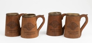 Set of four folk art Australian cedar beer tankards with brass linings, each one carved with the R.A.F. crest and R.J. MITCHELL, POONA, 1945", 13cm high
