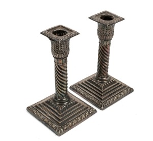 A pair of antique sterling silver candlesticks with barley twist stems and palm capitals, 19th/20th century, stamped "FLAVELLE SYDNEY", 15cm high, weighted bases.