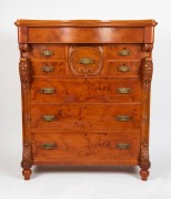 An antique Huon pine chest of eight drawers with serpentine front and carved floral corbel, 19th century, 139cm high, 118cm wide, 56cm deep