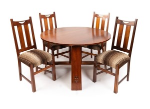 An Australian blackwood Arts & Crafts circular dining table with four matching chairs, early 20th century, the table 74cm high, 132cm diameter