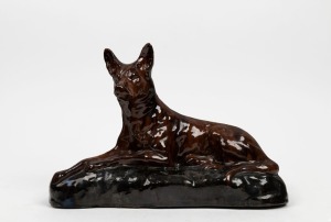 A pottery kelpie dog statue, 26cm high, 36cm wide