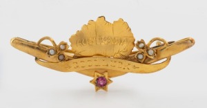 "AUSTRALIA GOOD LUCK" antique Australian yellow gold boomerang and map brooch, set with seed pearls and red stone, circa 1900, marks illegible, 5cm wide 3.2 grams