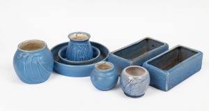 MELROSE WARE group of seven duck egg blue glazed pottery vases and flower troughs, three examples with gumnut and gum leaf decoration, the circular flower trough 22cm diameter