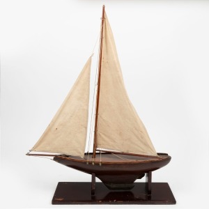 An antique Australian timber pond yacht on stand, early 20th century, 65cm high, 53cm long