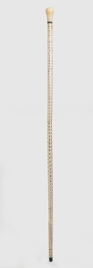 An antique walking stick with carved whale's tooth handle, baleen spacer and ferrule, on a segmented stingray vertebrae shaft, 19th century, 92cm high