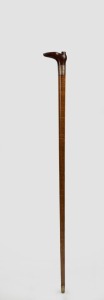 An antique Australian walking stick with carved boot handle, silver collar on a fiddleback blackwood shaft with brass ferrule, 19th century, 79cm high