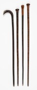 Four assorted antique walking sticks with unusual segmented leather shafts, 19th century, the largest 88cm high