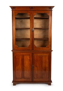 An antique Australian blackwood display cabinet, glazed top fitted with two adjustable shelves, the sides with fielded panels and bracket supported cornice, circa 1900, 199cm high, 110cm wide, 33cm deep