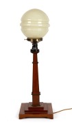 An Australian Art Deco table lamp made from silky oak, blackwood and other native timbers, with glass shade, circa 1930, 82cm high