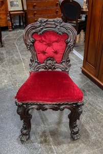 A fine quality Colonial ceremonial chair with ornate carving and recessed casters, mid 19th century