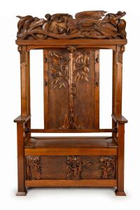 An Arts & Crafts hallstand carved with Australian flora and fauna including possums, koala, cockatoo, gumnuts and leaves, early 20th century, ​​​​​​​206cm high (including cockatoo head piece), 127cm wide, 40cm deep