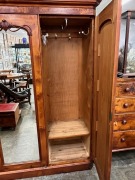 An antique Australian huon pine three door wardrobe with central mirrored door and carved decoration, 19th century. Note: Fine select cuts of&nbsp; birdseye huon pine have been used in the construction of this piece shoring lovely&nbsp;colour and patination. 211cm - 3