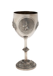 THE CARLTON FOOTBALL CLUB CHALLENGE CUP - 1876 - WON BY GEELONG PLAYER, WILLIAM "TRUSTY" HALL OF THE GEELONG FOOTBALL CLUB A sterling silver cup depicting a footballer about to kick for goal and engraved "Carlton Football Club Challenge Cup for DROP KICK won by W. HALL * 1876 * 68 YDS"; 180mm.