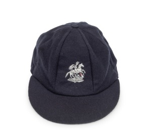 DEVON MALCOLM (England): Malcolm's England "Touring" Test Team Cap, navy blue wool with embroidered St. George and the Dragon, endorsed in pen "D.M." on the Albion label in the crown of the cap. From Malcolm's last tour of Australia in 1994-95.