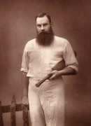 W.G. GRACE, posing in his cricket whites with a bat under his arm, the portrait by Herbert Rose Barraud, circa 1885; framed and glazed, overall 48 x 41cm. - 2