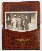 A Smythson of Bond Street leather wallet, with multiple internal compartments and gilt lettering: "With Congratulations and Best Wishes to MR. E.H. BROMLEY from W. Harrison. Australia v England 1934."&nbsp; The wallet contains are original photo postcard of Br
