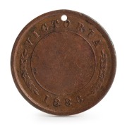 1886 Football Medal, showing on front a footballer running with ball in hand and "Stokes and Martin, Melbourne"; verso with "Victoria 1886" with leaves between the word and the date with a blank centre; holed at top. Believed to be associated with an inte - 2