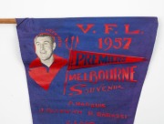 1957 MELBOURNE&nbsp;Grand Final souvenir pennant listing all the team members and showing their positions on the field, with club captain, John Beckwith depicted at top left. 42cm. A particularly rare example we have not previously seen. - 2