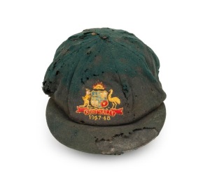 BILL JOHNSTON'S AUSTRALIAN 1947-48 BAGGY GREEN TEST TEAM CAP, green wool with embroidered Australian cost-of-arms and the dates "1947-48"embroidered to the front panel; "Farmers Sydney" label to the inside crown. Poor condition. Bill Johnston played in 40 Tests for Australian between 1947-55 and was one of the Invincibles of 1948. Provenance: Charles Leski Auction 380, Lot 103, December 2010.