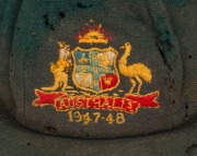 BILL JOHNSTON'S AUSTRALIAN 1947-48 BAGGY GREEN TEST TEAM CAP, green wool with embroidered Australian cost-of-arms and the dates "1947-48"embroidered to the front panel; "Farmers Sydney" label to the inside crown. Poor condition. Bill Johnston played in 4 - 2