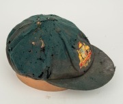 BILL JOHNSTON'S AUSTRALIAN 1947-48 BAGGY GREEN TEST TEAM CAP, green wool with embroidered Australian cost-of-arms and the dates "1947-48"embroidered to the front panel; "Farmers Sydney" label to the inside crown. Poor condition. Bill Johnston played in 4 - 3