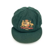 AN AUSTRALIAN TEST TEAM BAGGY GREEN dated "1956" (player unknown), green wool with the Australian coat-of-arms and the year "1956" embroidered to the front panel. Fairly good condition but with some holes/wear to the left and rear of the cap.&nbsp;Provenance: 