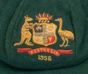 AN AUSTRALIAN TEST TEAM BAGGY GREEN dated "1956" (player unknown), green wool with the Australian coat-of-arms and the year "1956" embroidered to the front panel. Fairly good condition but with some holes/wear to the left and rear of the cap.&nbsp;Provenance: - 2