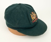AN AUSTRALIAN TEST TEAM BAGGY GREEN dated "1956" (player unknown), green wool with the Australian coat-of-arms and the year "1956" embroidered to the front panel. Fairly good condition but with some holes/wear to the left and rear of the cap.&nbsp;Provenance: - 3