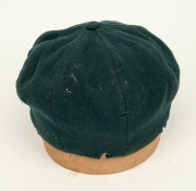 AN AUSTRALIAN TEST TEAM BAGGY GREEN dated "1956" (player unknown), green wool with the Australian coat-of-arms and the year "1956" embroidered to the front panel. Fairly good condition but with some holes/wear to the left and rear of the cap.&nbsp;Provenance: - 4