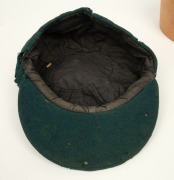 AN AUSTRALIAN TEST TEAM BAGGY GREEN dated "1956" (player unknown), green wool with the Australian coat-of-arms and the year "1956" embroidered to the front panel. Fairly good condition but with some holes/wear to the left and rear of the cap.&nbsp;Provenance: - 6